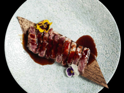tagliata di carne di manzo nobile giapponese wagyu servita con fiori eduli